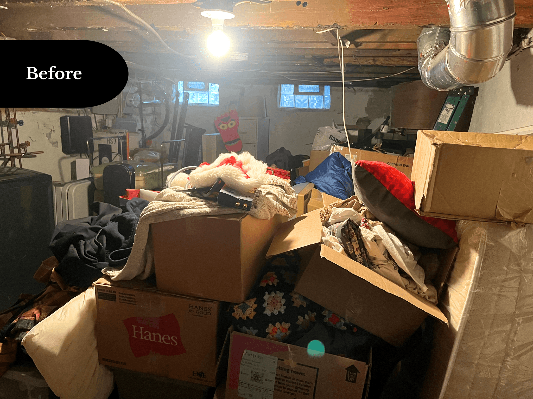 Basement filled with boxes and stored items, before transformation