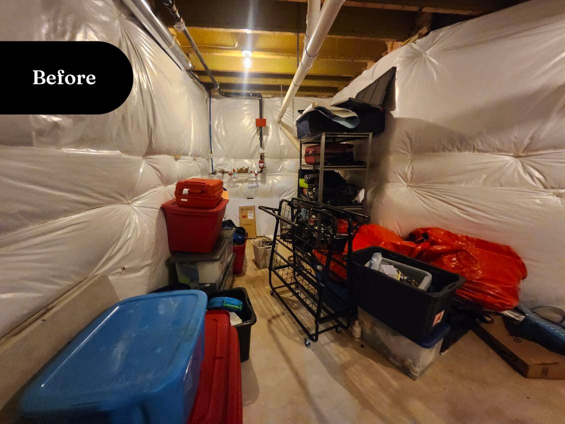 Cluttered back room packed with totes and storage bins, front view, before transformation