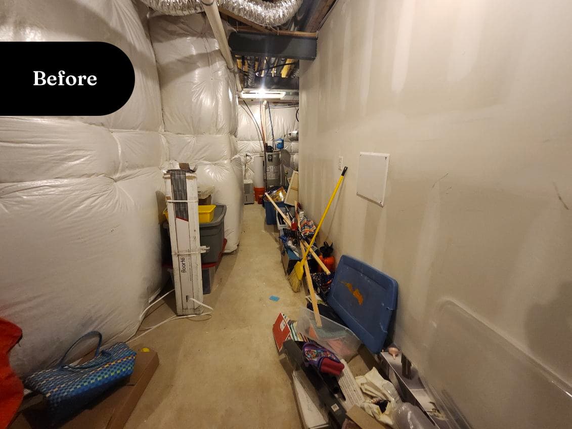 Cluttered back room from the side with boxes along the walls, before transformation
